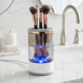 Makeup brush cleaner with LED light and multiple brush holders on a white background